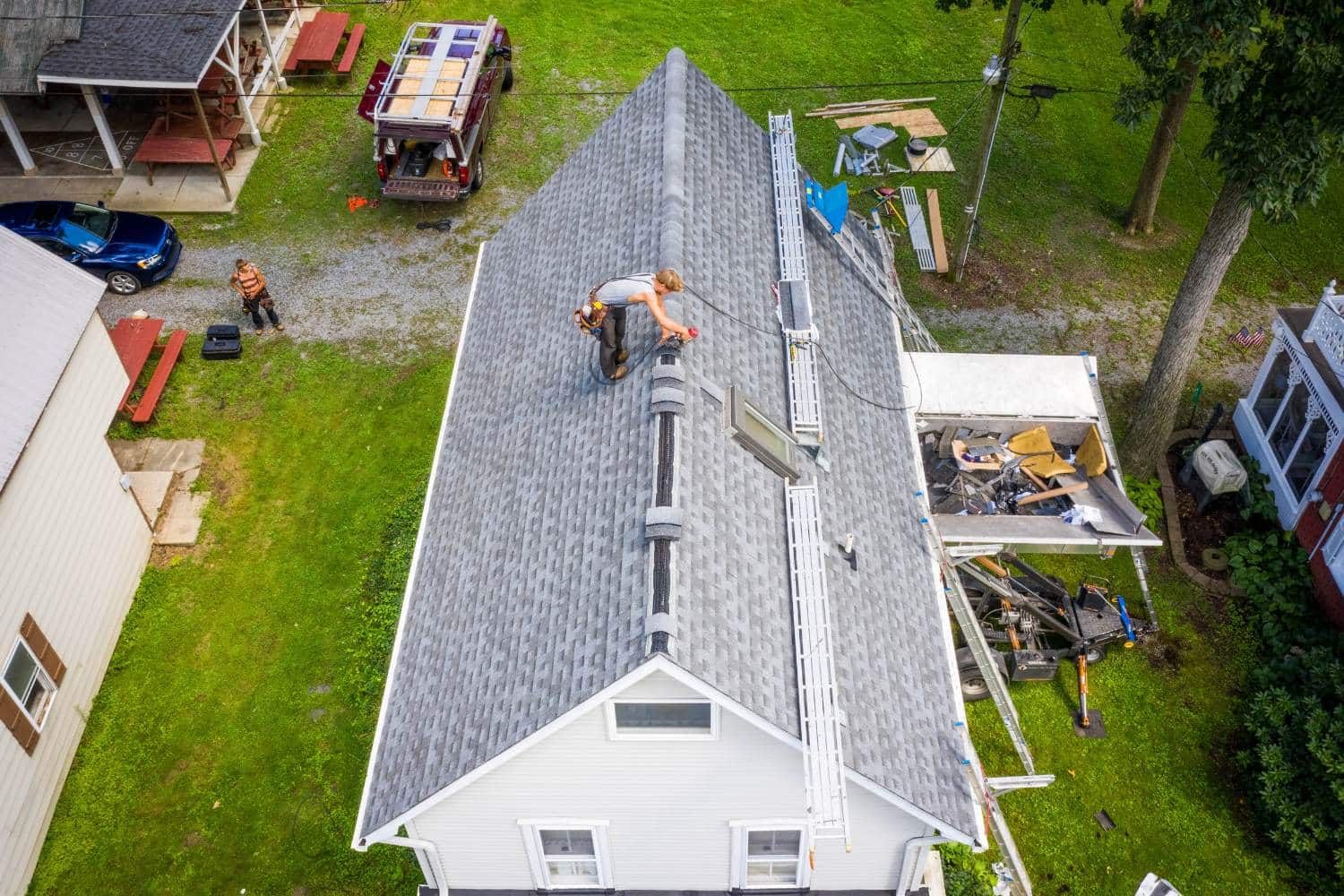 Roofers at work on asphalt roof replacement on house in lancaster pa