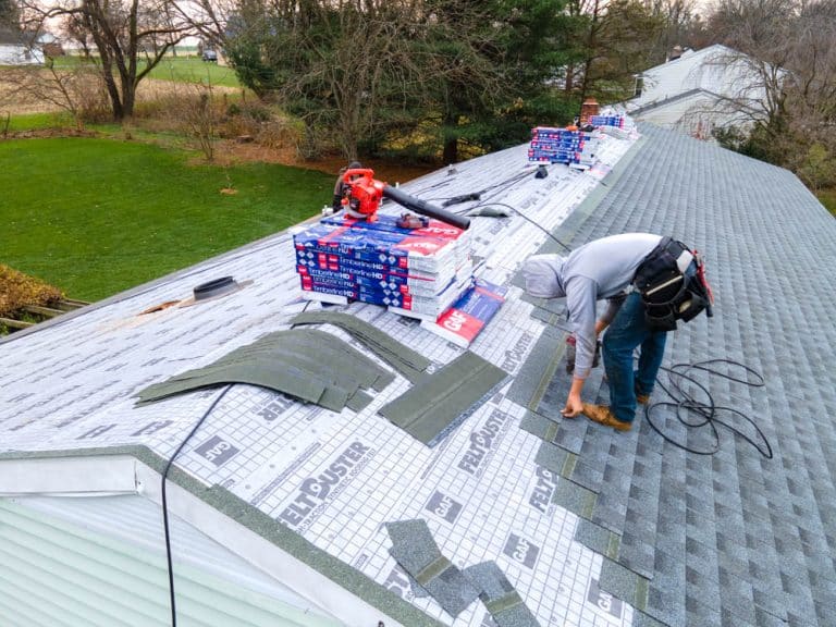 men replacing a roof