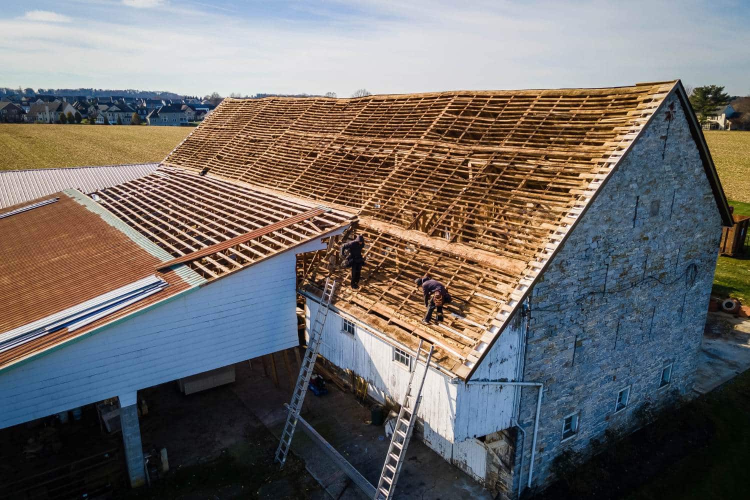 View of roof replacement process on older building