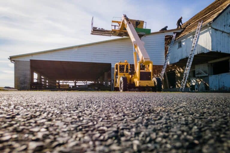 Elmer's Roof Replacment process with view of ground, building, and construction equipment