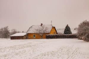 Snow Covered House in need of a winter roof replacement *C